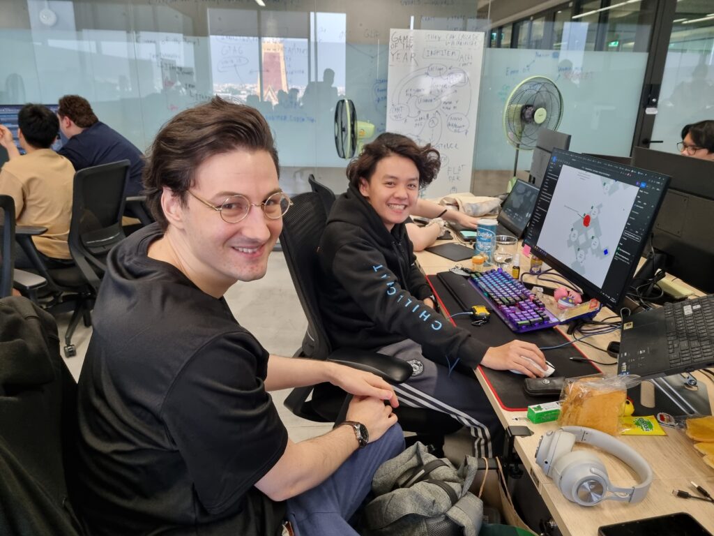 two Chillchat Studio designers smiling together while working