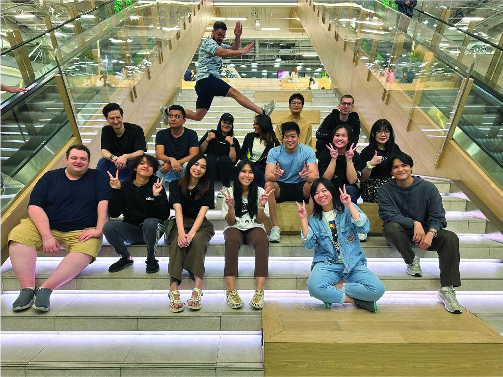 full Chillchat Studio team taking a group photo on stairs inside